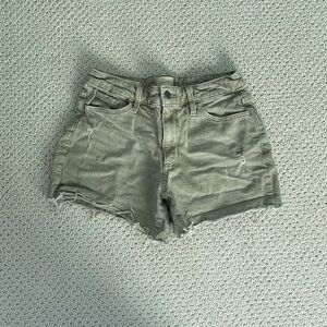 Distressed green jean shorts